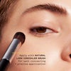 Model applying concealer tint with natural look concealer brush